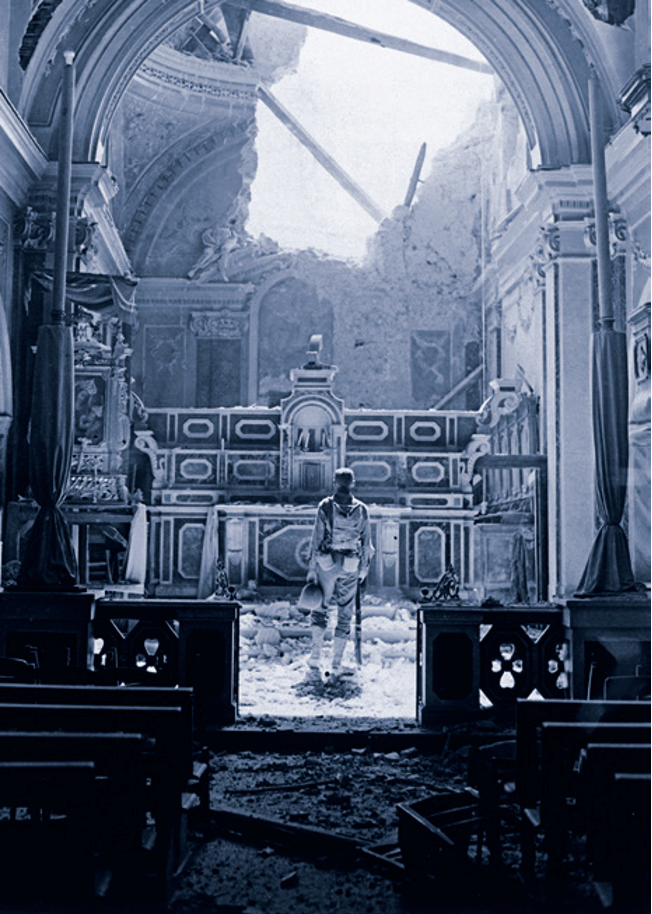 An American soldier in a bomb-damaged church in Italy