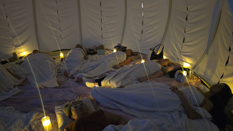 Luxury meditation cabana setup on Sydney Harbour with serene décor and comfortable seating for a wellness event

