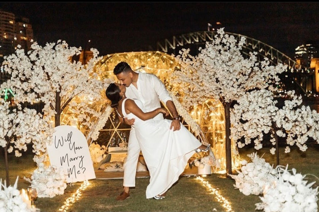 Nighttime proposal setup in luxury igloo with Sydney Harbour Bridge views and romantic lighting