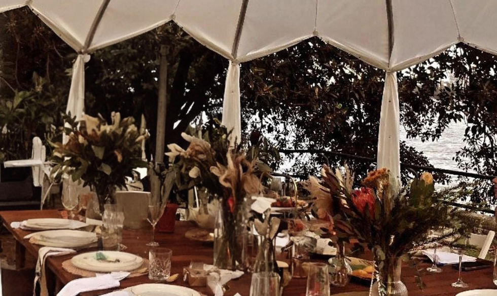Iglooze Cabana open-frame structure with dining table and chairs, Sydney Harbour setting, daytime