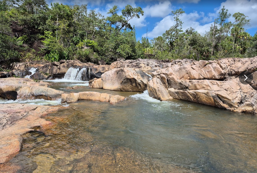 Rocky natural swimming pools with small cascading falls at Rio On Pools in Belize