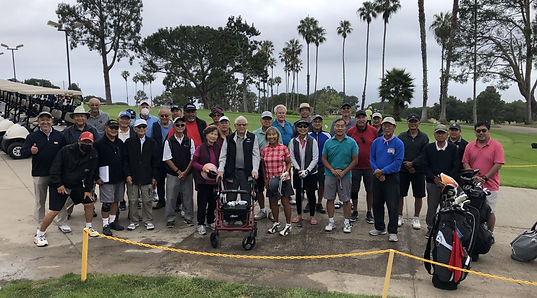 group picture of golf tournament participants at the golf course