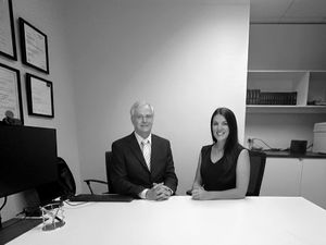 Dennis Barton and Liz Rae sitting in the boardroom at the Andep Perth Office
