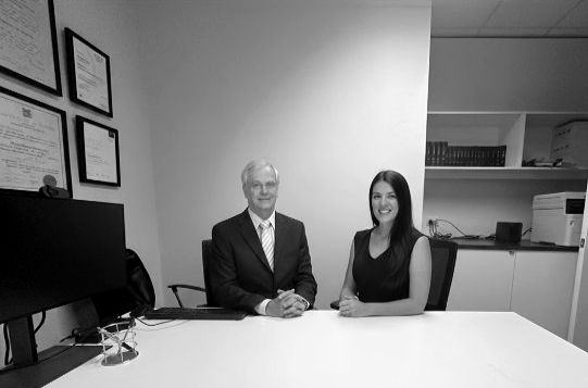 Dennis Barton and Liz Rae sitting in the boardroom at the Andep Perth Office