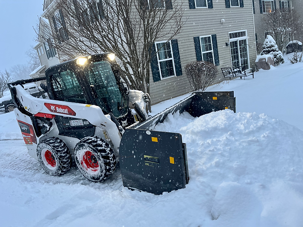 Skid steer snow plowing