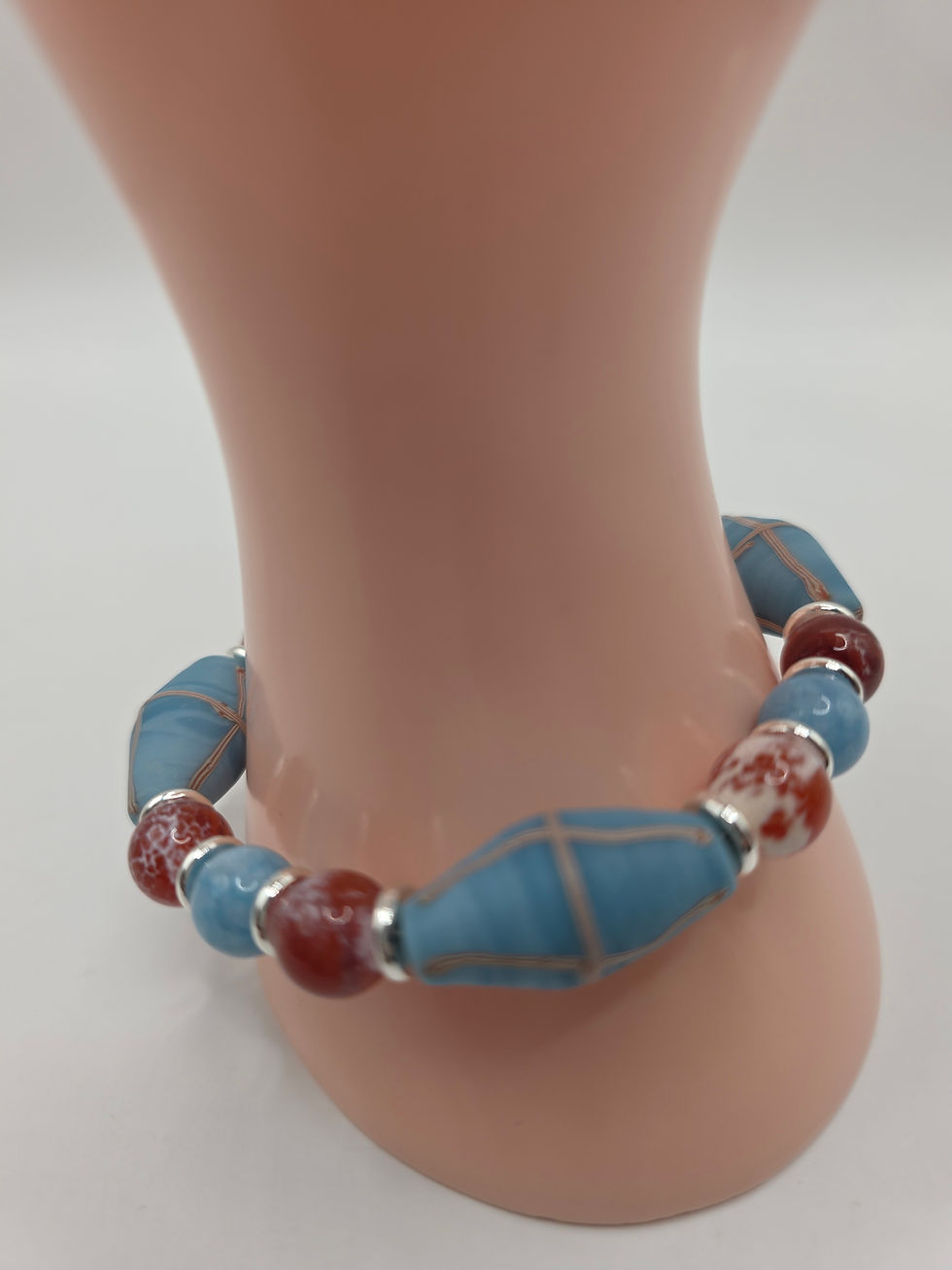 Thumbnail: Handmade bracelet with alternating fire agate, blue chalcedony, and painted glass beads finished with sterling silver.