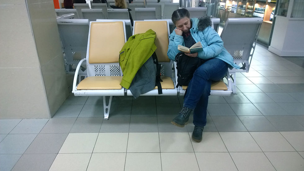 Woman-Reading-in-Airport-Waiting-Area-Family-in-New-York-Tours