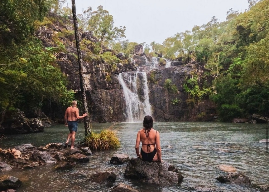 Couple in front of a waterfall in Whitsunday Islands