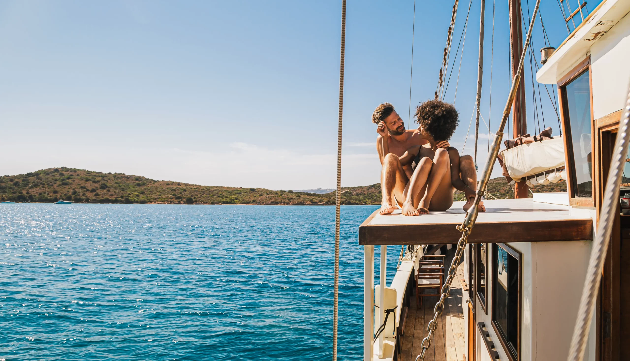 Couple sitting on a boat in Sardinia