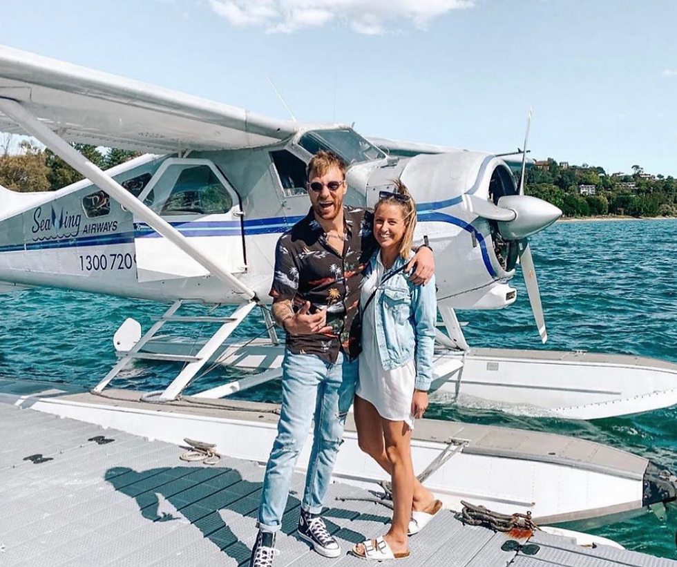 Couple Standing by a Seaplane