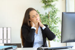Woman At Dest Holding Neck.jpg