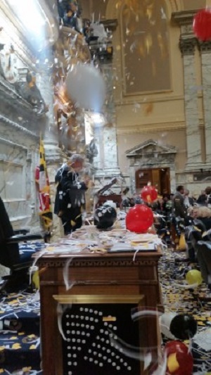 Confetti falls on House Speaker Michael Busch