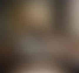 Portrait of owner and dog hanging above couch