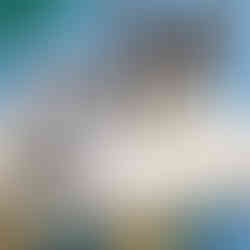 Black and white cat with green eyes loafing on a cat tower