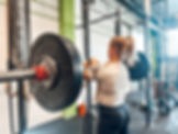 Female athlete training with a barbell