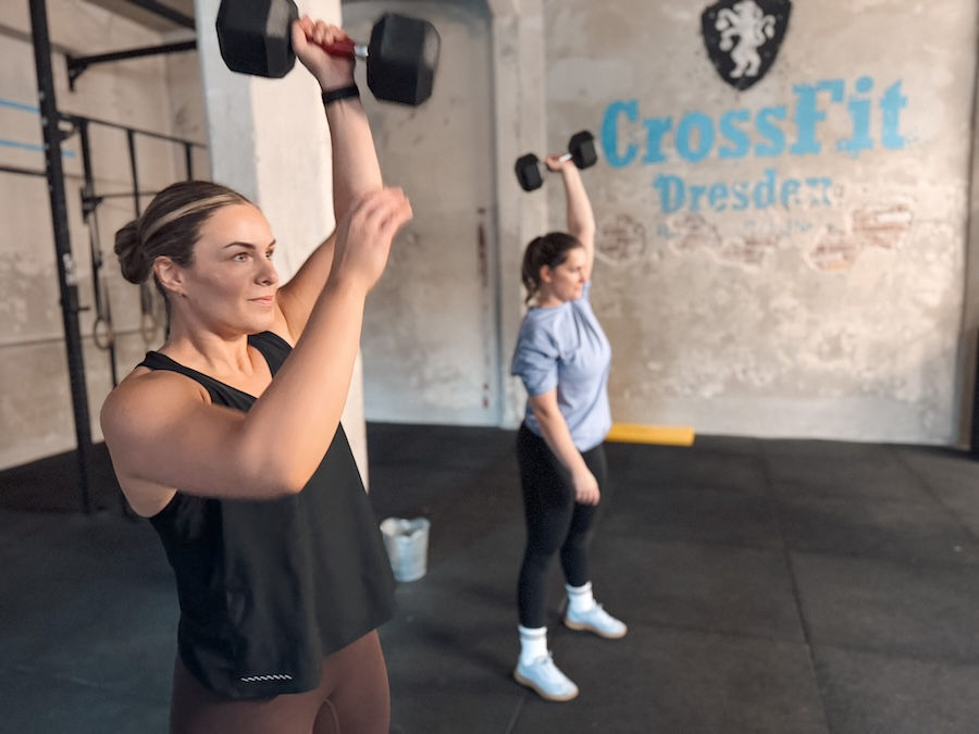 Female athletes training with dumbbells