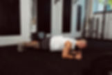 Athlete trains his core with a plank