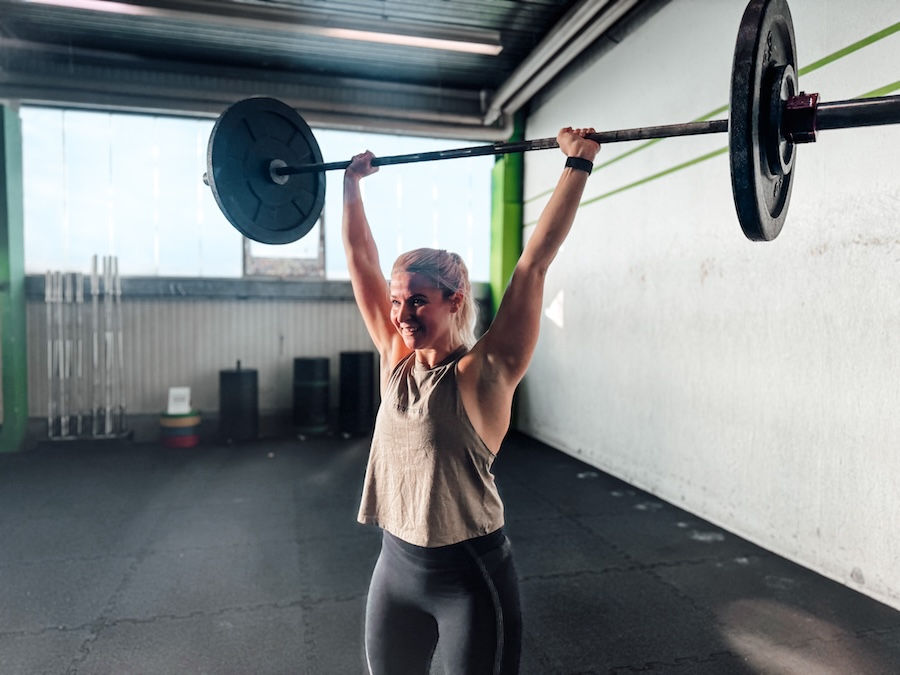 Female athlete with a barbell over her head