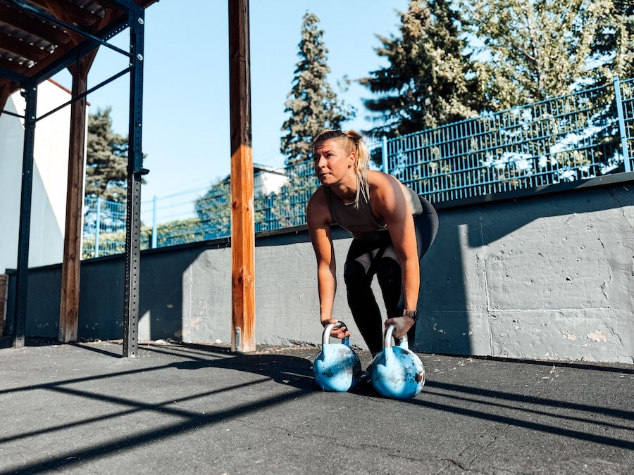 Female athlete with kettlebells