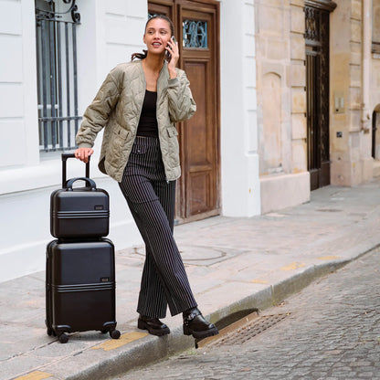 Man on a Curb with Expedition Polycarbonate Luggage