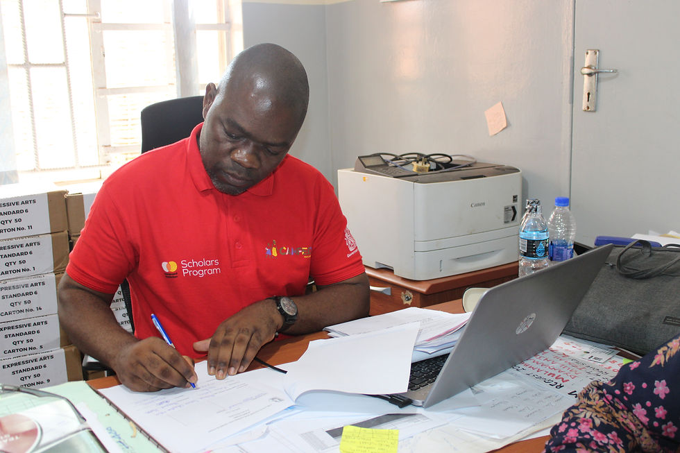Principal Education Officer Hartley Kaluwa signs the delivery note acknowledging receipt of the laptop.