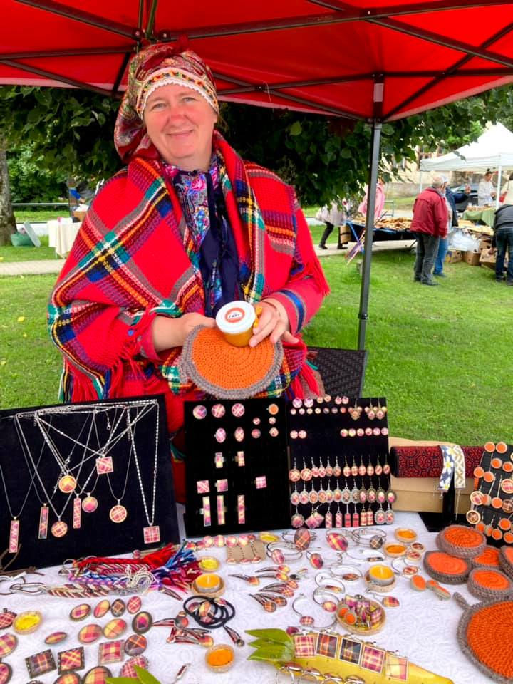 A Suiti woman in her traditional costume selling handcrafts at the market in Alsunga