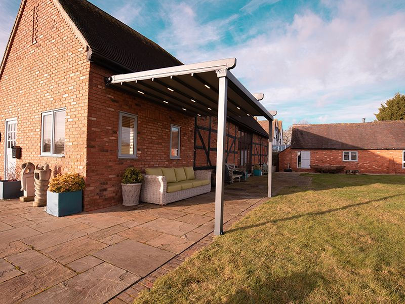 Retractable Roof Pergola with integrated LED Lights over  the back terrace