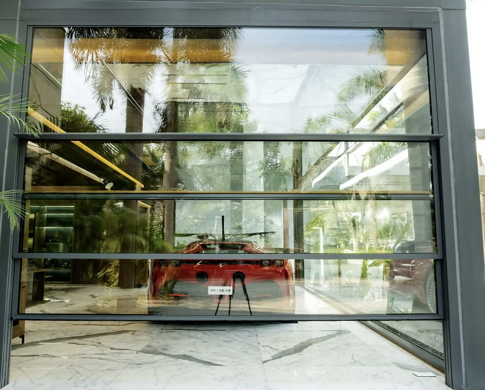 Red sports car visible through large guillotine window, with palm trees reflecting. Marble floor inside and outside. 