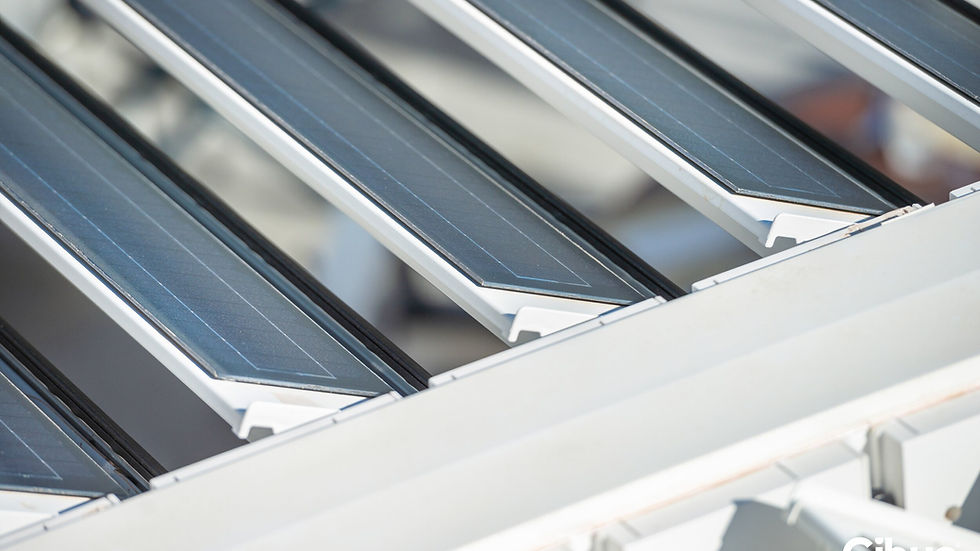 Close-up of louvered solar panels. The panels have a sleek design with light reflecting off their surfaces. 