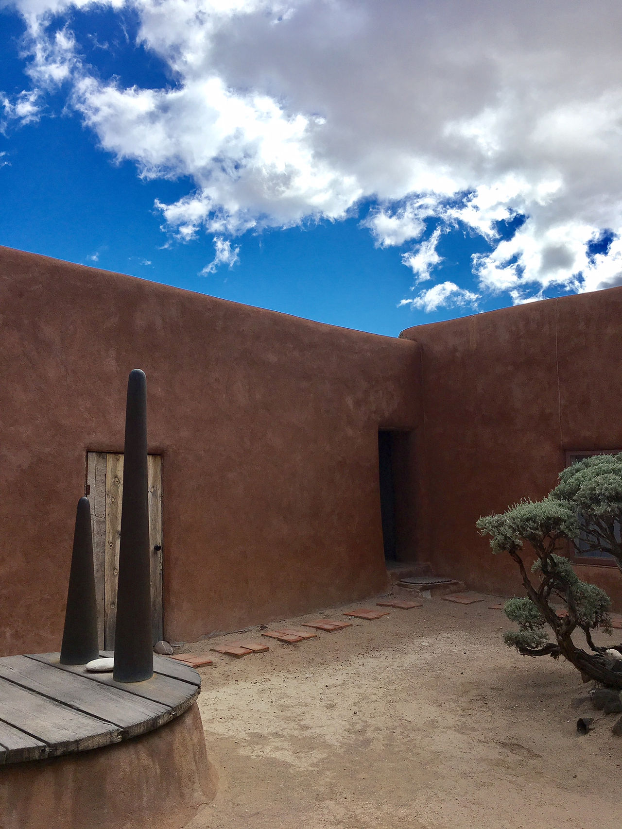 This is the infamous "black door" O'Keeffe painted many versions of. The sculptures are hers as well.
