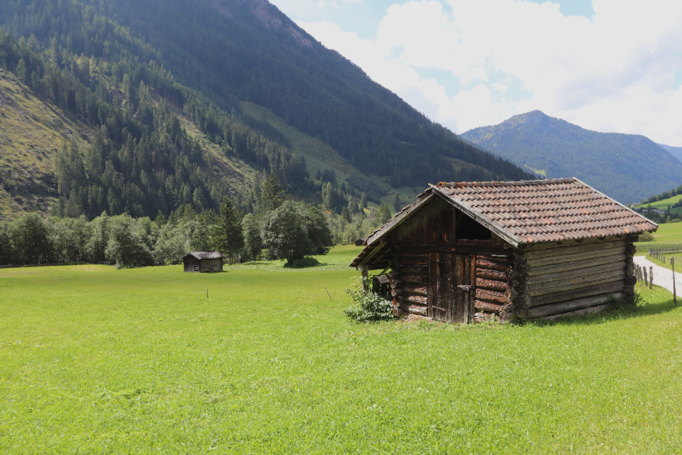 Old hay barns in the Valsertal valley – silent witnesses to rural tradition against an impressive mountain backdrop