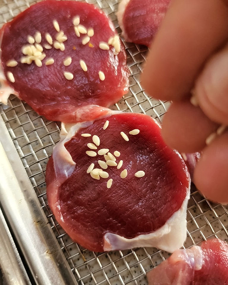Preparing Duck Jerky Dog Treat with sesame seeds