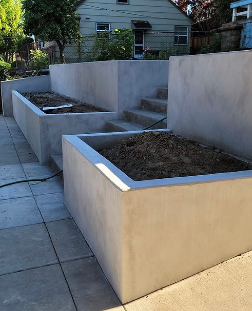 Monopoured concrete retaining wall in front of old fashioned residential home in Beaverton