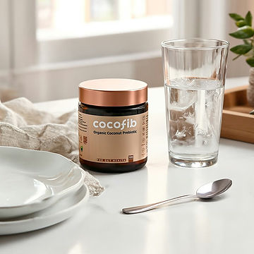 CocoFib supplement jar next to a glass of water