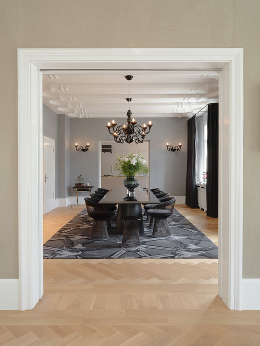 Open living space showroom flat Dusseldorf — view towards dining area with stucco ceiling and parquet flooring