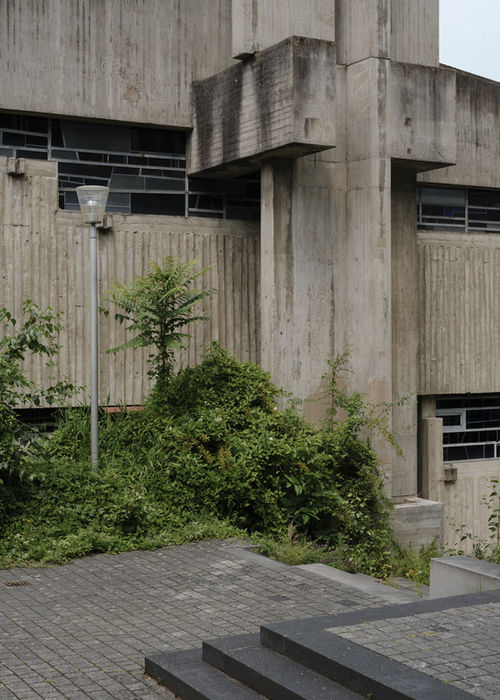 Rear perspective of church facade — monumental concrete structure with sculptural geometry