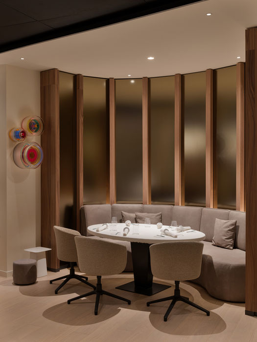Seating area in La Vie Dusseldorf — curved sofa and round reflective design element