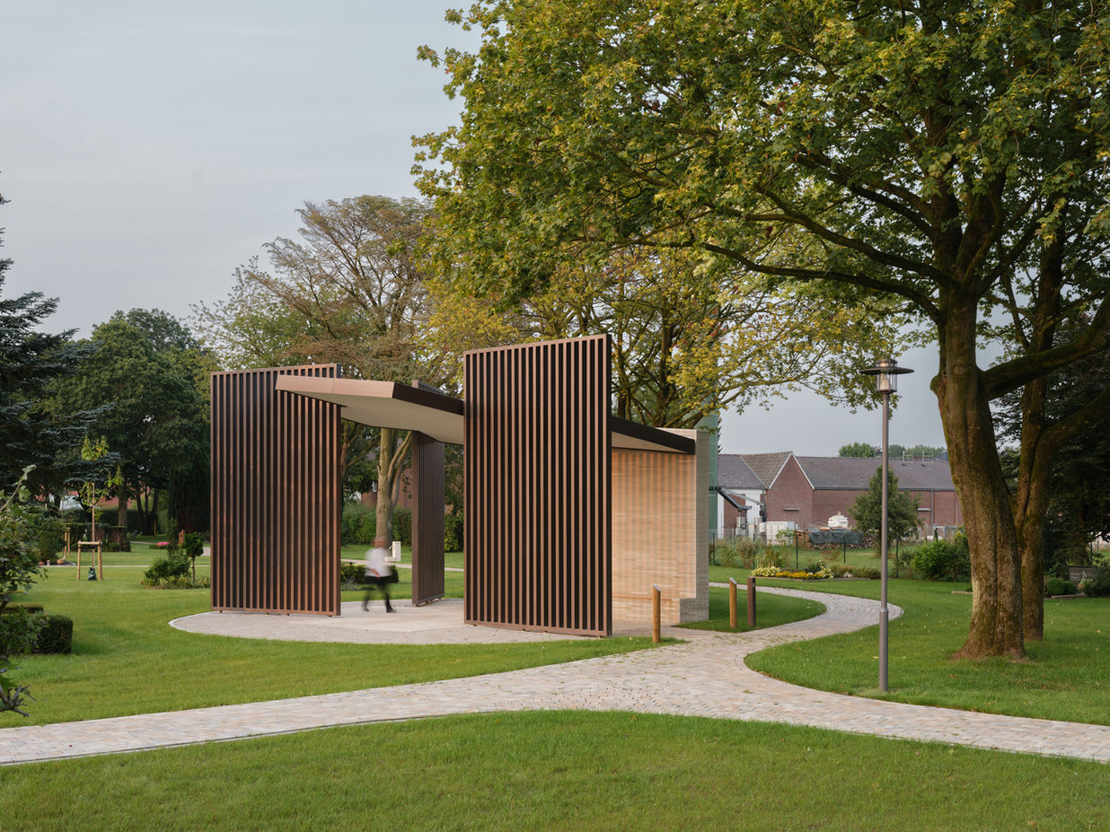 Pavilion exterior scene — person in motion blur under steel structure with tree shadows and architectural framing