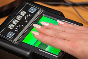 The process of scanning fingerprints during the check at border crossing. Female hand puts