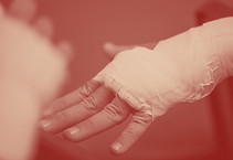 An MMA fighter has his hands wrapped bef