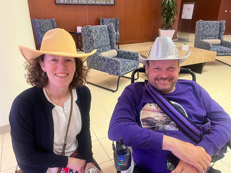 Lisa Latchford and Michael Rogers wearing cowboy hats at the National APSE conference in Dallas.