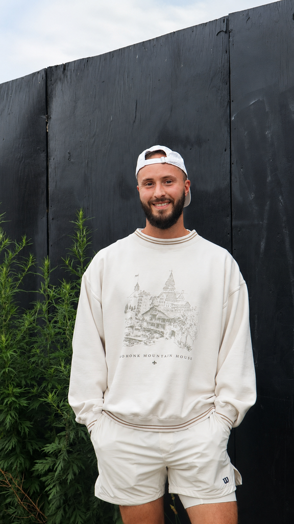 Portrait of Brett Spano smiling outdoors near greenery