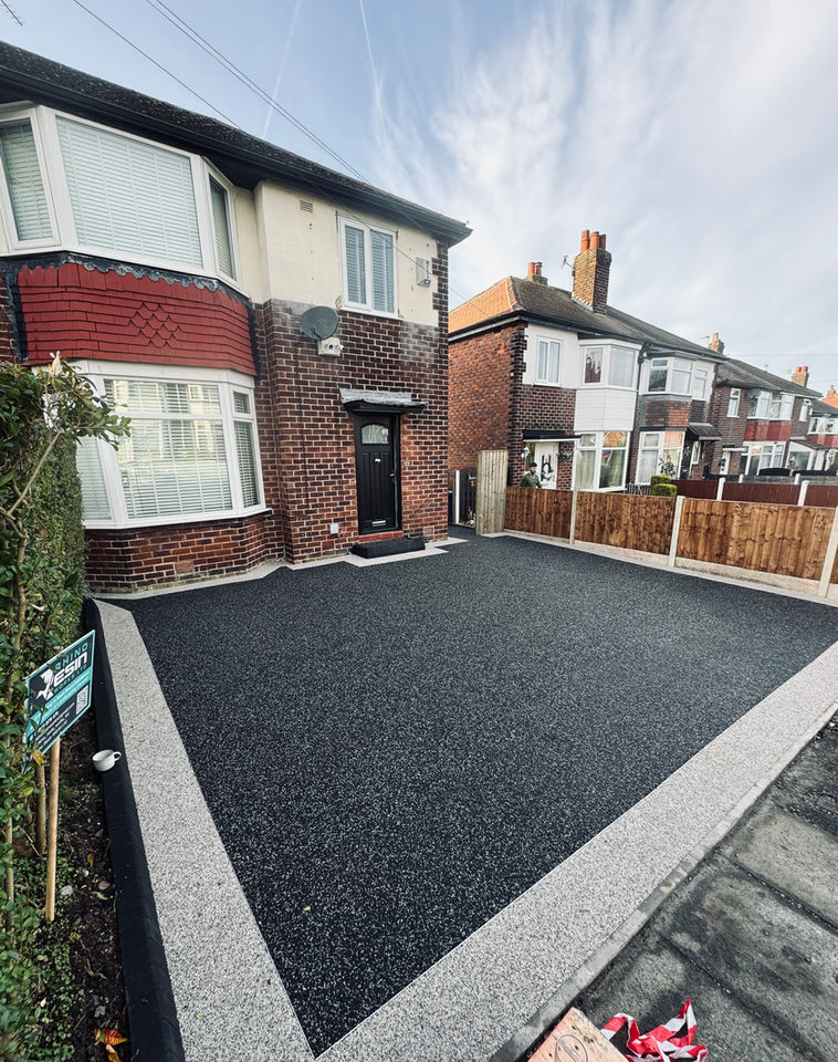 Dark grey Resin Bound Driveway With A Resin Boarder for a residential house.