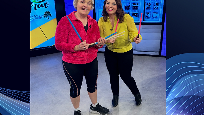 Sally and Megan standing with drumsticks in WHO studio