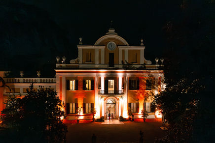 Elegant Italian villa lit up at night for a wedding reception in Emilia-Romagna