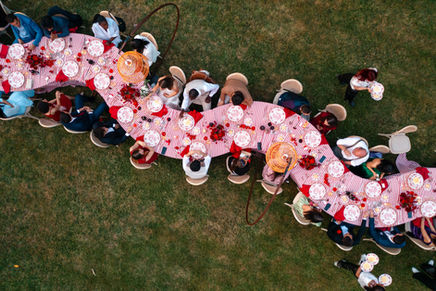 Long outdoor wedding table in Italy with guests enjoying a convivial dinner under the stars