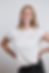 Annick, a woman in a white t-shirt in front of a light grey background, who is a marketing specialist with a focus on helping startups grow