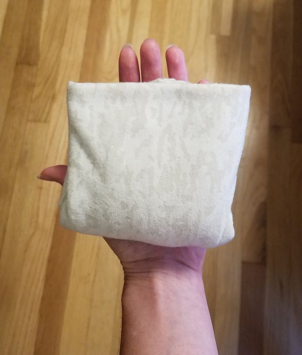 a shirt folded small in palm of hand
