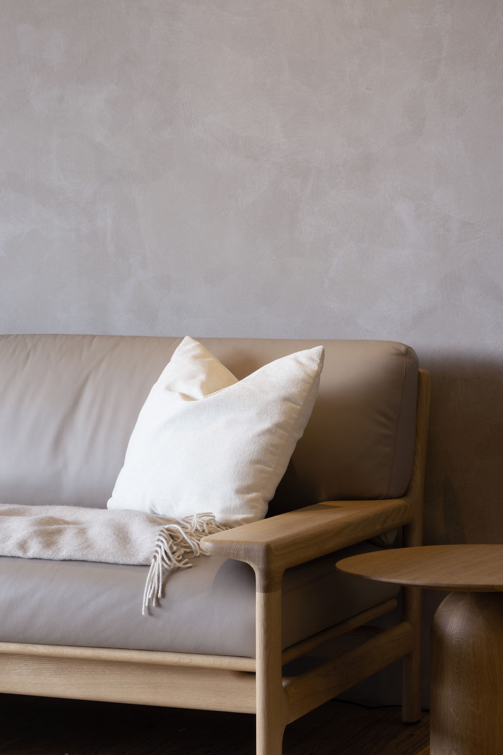An Idyllic Home sofa detail positioned beside the living area, creating a quiet corner for rest and reflection.