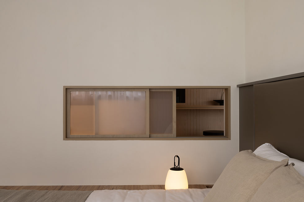 Hitotema Home bedside detail featuring a horizontal internal window that maintains visual connection between adjacent spaces.